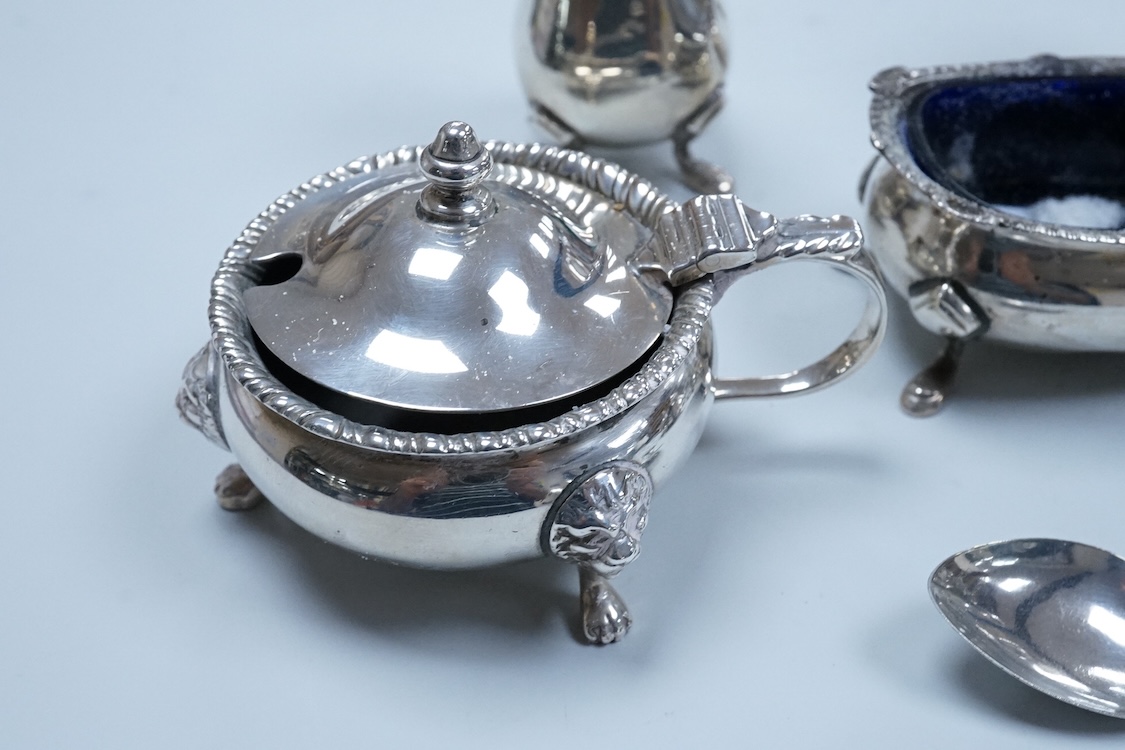Two George VI silver three piece condiment sets by Walker & Hall, London, 1936/7, together with a modern silver mounted pepper mill by Mappin & Webb and two plated spoons.